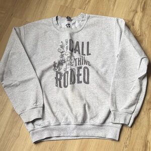 Gray “And They Call the Thing Rodeo” Graphic Unisex Sweater